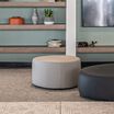 small sand grey ottoman in lounge setting 